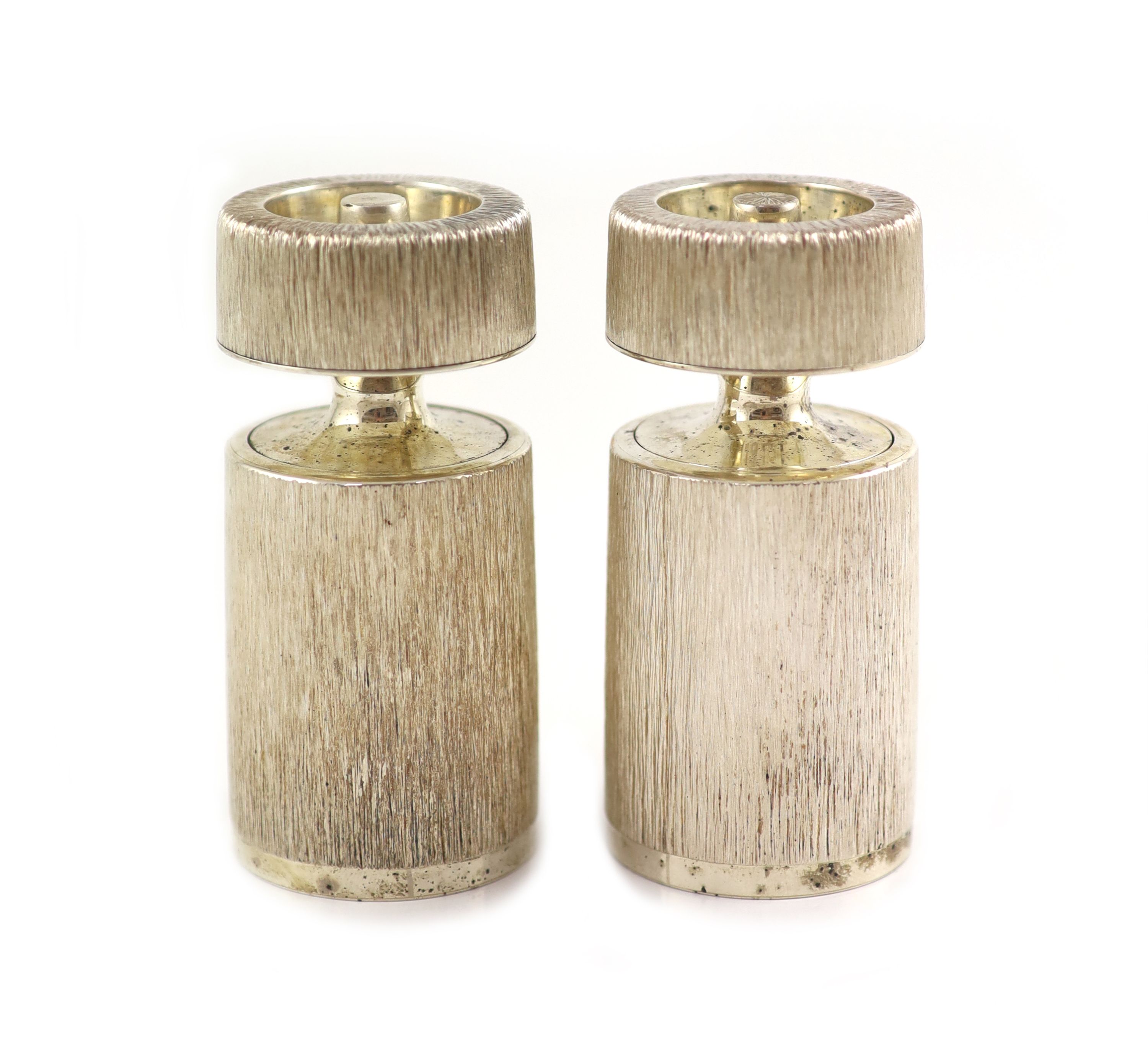 A pair of textured silver salt and pepper mills by Adrian Gerald Benney